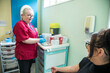 © Connect Images - Nurse preparing equipment while patient waits