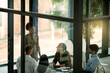 © Katleho Seisa/peopleimages.com - Boardroom, speaker and woman in collaboration, talking and group of colleagues, listening and together. Workshop, training and employees in business, journalist and notes for meeting or presentation