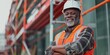 © LukaszDesign - Building engineer, architect, and construction worker with a black man on scaffold showing positivity, motivation, and vision. Mature masculine contractor smiling.