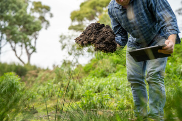 farmer holding soil looking at soil carbon in the america