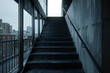 © Liaqat - Jet black staircase in a city loft, photographed from the side on a balcony.