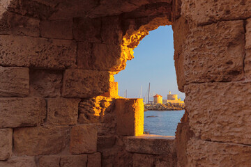 Wall Mural - Historic stone arch ruins in Rhodes with boat visible through the window, Greece