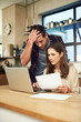 © peopleimages.com - Stress, couple and laptop in kitchen with documents for financial bills, online payment and banking. Marriage, debt and anxious man with woman on computer for mortgage, insurance paperwork or budget