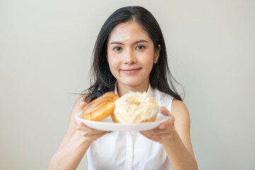 Wall Mural - Portrait of happy smile asian young woman, girl temptation food, holding donut plate, enjoy eating sugar glazed doughnut delicious dessert sweet, snack tasty. Eat fast food, junk food meal getting fat