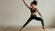 © NooPaew - Full-length shot of a fit young woman outdoors, performing a deep lunge stretch on a sunny day, showcasing her flexibility and strength against a scenic backdrop.