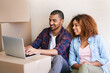 © Lyndon Stratford/peopleimages.com - New home, boxes and couple with laptop, relax and property with efilling, real estate and goals. People, apartment and man with woman, cardboard or computer to pay mortgage, rent and bonding together