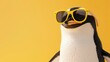 © Fatema - 3d illustration of cute happy penguin wearing yellow sunglasses, smiling and looking at camera, on solid background
