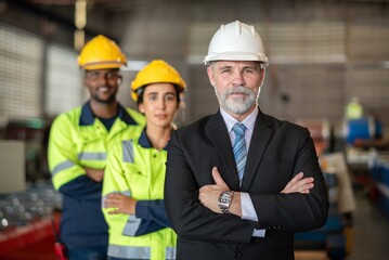 mature older boss engineer with beard mustache on face wear helmet standing smile and hand show good thumb at construction factory site with worker leader team for happy working in factory site.