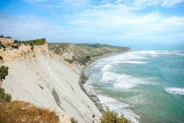 Wall Mural - Coastal cliffs sheer to sea at Cape Kidnappers in Hawkes Bay New Zealand.