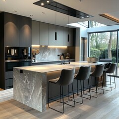 A modern kitchen with an oversized island and pendant lighting