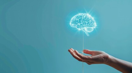 Wall Mural - a transparent brain shape with glow dots and connection line floating above hand on blue background