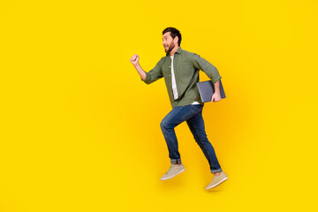 Sticker - Full size photo of nice young man jump run laptop empty space wear shirt isolated on yellow color background