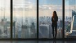© tantawat - A professional woman standing in front of a large window with a cityscape view, with ample space for copy space on the right side.