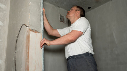 Mature man construction worker measuring