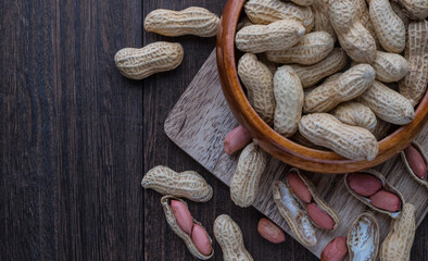 Background image with peanuts in wooden plate