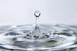 © Maryna - A single water droplet is descending into a container filled with water