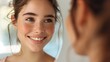 © Orod - Photography of a closeup face in front of an oval mirror showing a bright smile with blue eyes., Closeup of a smiling face with blue eyes and freckles in an oval mirror with a soft background.