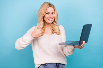 Wall Mural - Photo of charming adorable woman wear trendy white clothes hold netbook thumb up isolated on blue color background