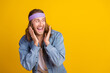 © deagreez - Photo portrait of attractive young hippie man raise hands look empty space wear trendy denim outfit isolated on yellow color background