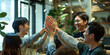 © wolfhound911 - a Japanese tech startup team celebrating a product launch with high-fives and cheers
