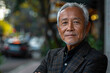 © SITI - Confident Elderly Asian Man in a Blazer Standing Outdoors on a City Street