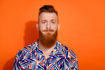 Photo of doubtful unsure guy dressed print shirt empty space isolated orange color background