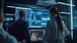 © Plaifah - A group of economists analyzing stock market graphs and charts on a large monitor in a research facility