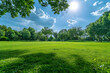 © john - Beautiful blurred background image of spring nature with a neatly trimmed lawn surrounded by trees against a blue sky with clouds on a bright sunny day.