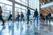 © Yuliia - Modern mall office environment crowds of people going to work exposition groups of businesspeople in modern tech park business advancements meeting sun shining through huge windows architectural park
