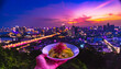 © CogiGen - someone enjoying their meal with a background of a busy cityscape. deliciously has him to taste; focus on photography in hand