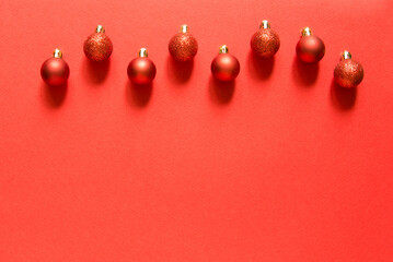 Wall Mural - row of red new year's balls. christmas composition with balls. red background. top view, flat lay. e