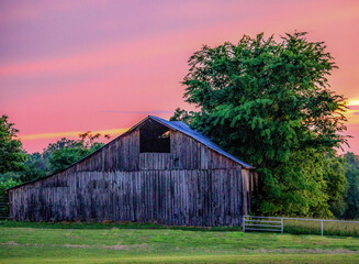 Wall Mural - A beautiful sunset over an old barn