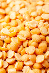 Wall Mural - Uncooked, split, yellow peas background. Dry peas grains. Close-up