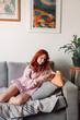 © Арина Романова - Young woman use smartphone in the room