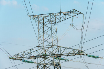 Wall Mural - Power lines and high-voltage wires against a background of blue sky and fluffy clouds. Energy infrastructure of Ukraine.