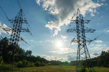 Wall Mural - Power lines and high-voltage wires against a background of blue sky and fluffy clouds. Energy infrastructure of Ukraine.