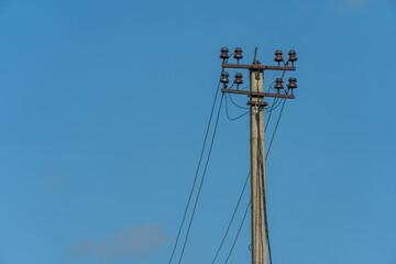 Wall Mural - Power lines and high-voltage wires against a background of blue sky and fluffy clouds. Energy infrastructure of Ukraine.