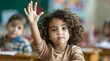 © Space Priest - Children raise their hands to answer in the classroom. Back To School concept. Background with selective focus