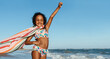© (JLco) Julia Amaral - Proud young girl having fun at the beach with a towel cape on a sunny day