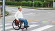 © 24K-Production - Woman with disability on a wheelchair on the city street.