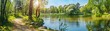 © Bi - Beautiful colorful summer spring natural landscape with a lake in Park surrounded by green foliage of trees in sunlight and stone path in foreground