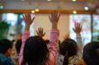 © waranyu - Children raise their hands to answer questions in the classroom, Taken from behind