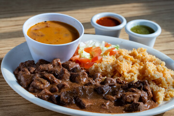 Wall Mural - Plate with beef, rice, beans, and veggies on a table