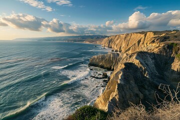 Wall Mural - A rugged coastline stretching into the distance, waves crashing against dramatic cliffs, panoramic view