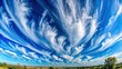 © wasana - Panoramic view of a clear blue sky with wispy cirrus clouds overhead