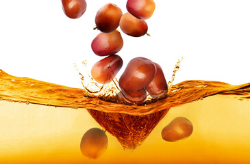 Wall Mural - Palm fruits falling into cooking oil on white background