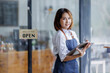 © David - Startup successful small business owner sme beauty girl stand with tablet smartphone in coffee shop restaurant. Portrait of asian tan woman barista cafe owner. SME entrepreneur seller business concept