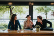 © qunica.com - Group of business colleagues having a misunderstanding and arguing at a desk inside a modern office setting.