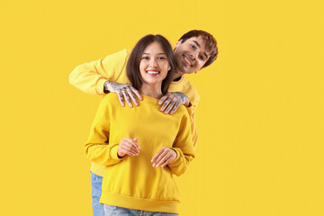 Poster - Young couple smiling on yellow background