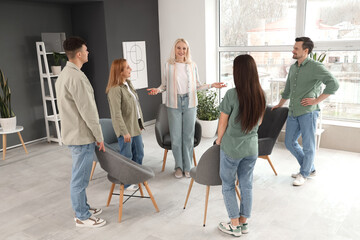 Poster - Female psychologist with people at group therapy session